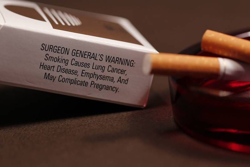 Cigarette package with surgeon general's warning about lung cancer - Confronting reality