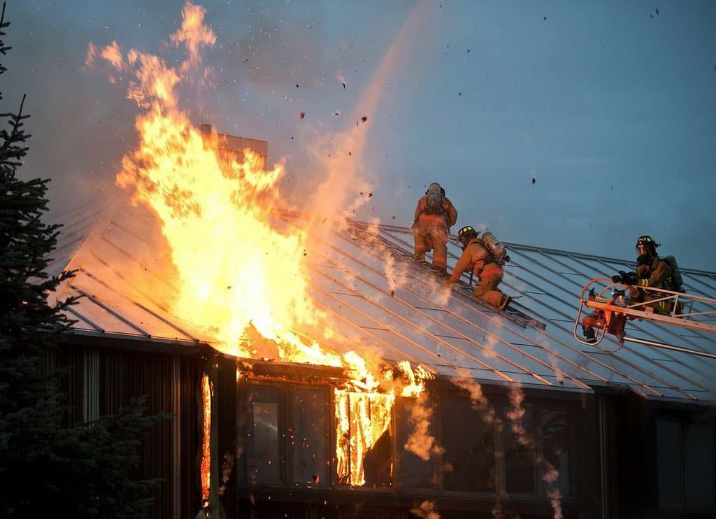 firemen putting out a fire in a building