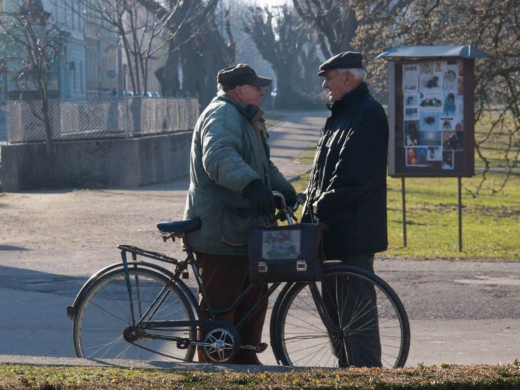 two men talking on the street