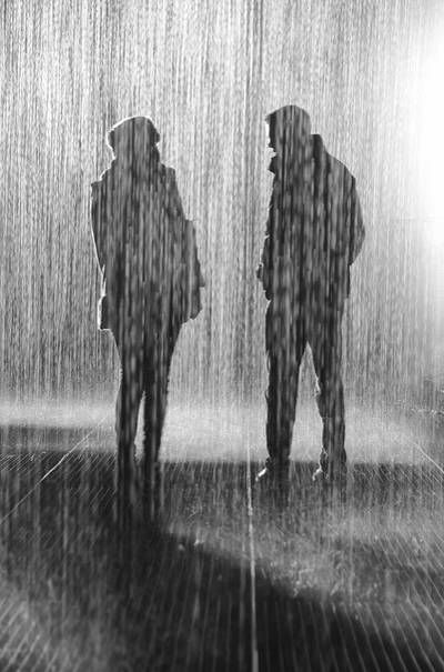 Woman and man having conversation in the pouring rain - An unconditional goodbye