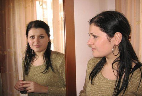 women looking at herself in mirror