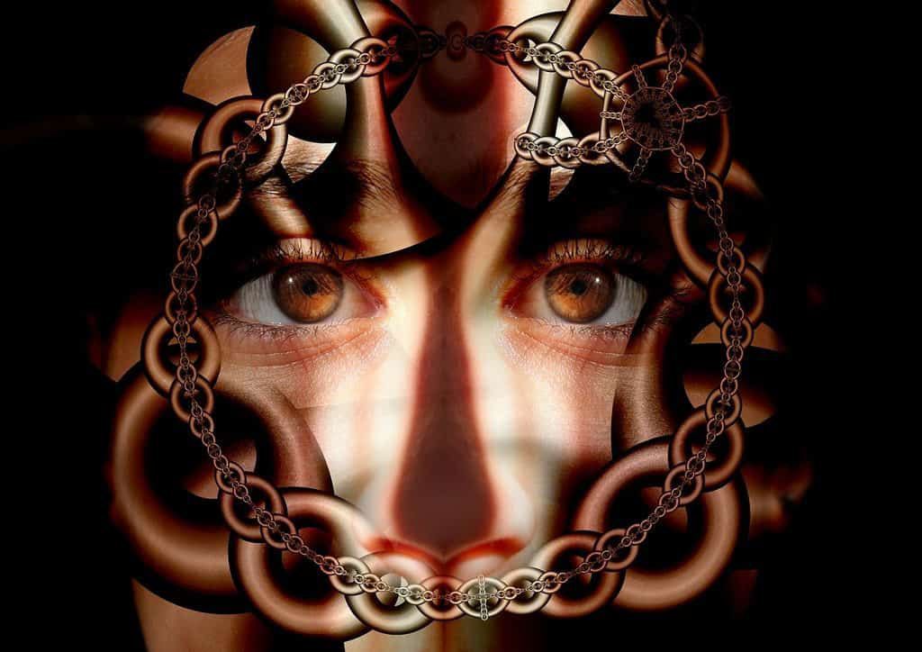 Face looking through chains