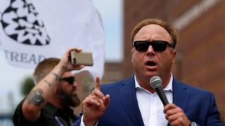 Alex Jones from Infowars.com speaks during a rally in support of Republican presidential candidate Donald Trump near the Republican National Convention in Cleveland, Ohio.