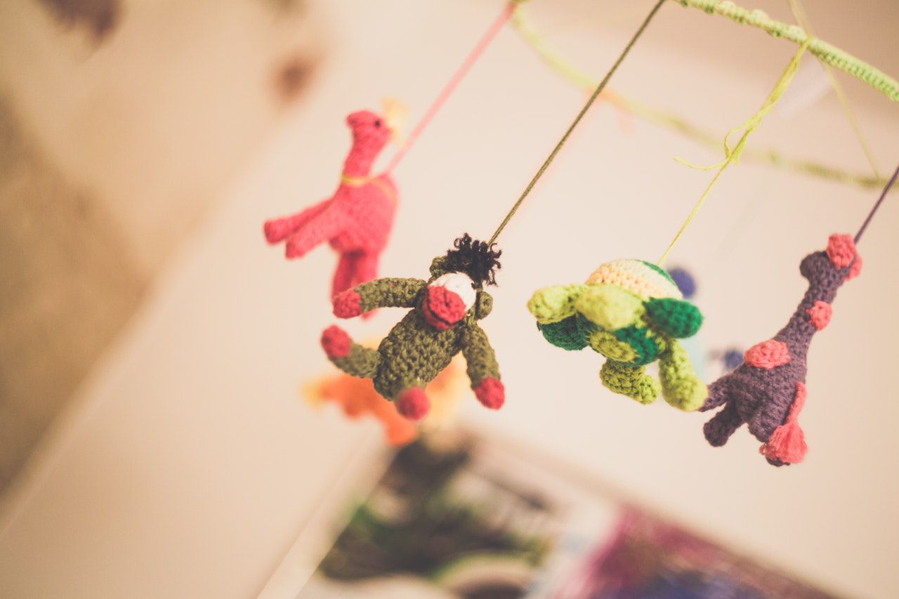 Colourful baby mobile hanging over crib - I'm a soul and I'm perfect