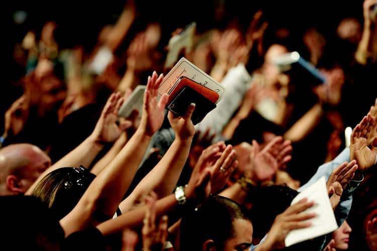 Christian congregation waving hands in worship - Nonsense and transcendent experience
