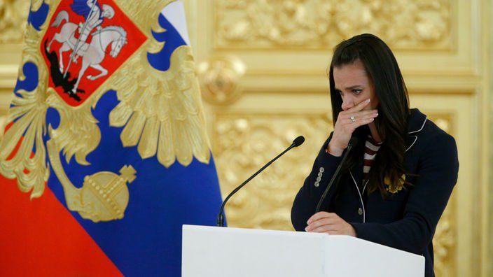 Jelena Issinbajewa mit russischer Flagge im Hintergrund